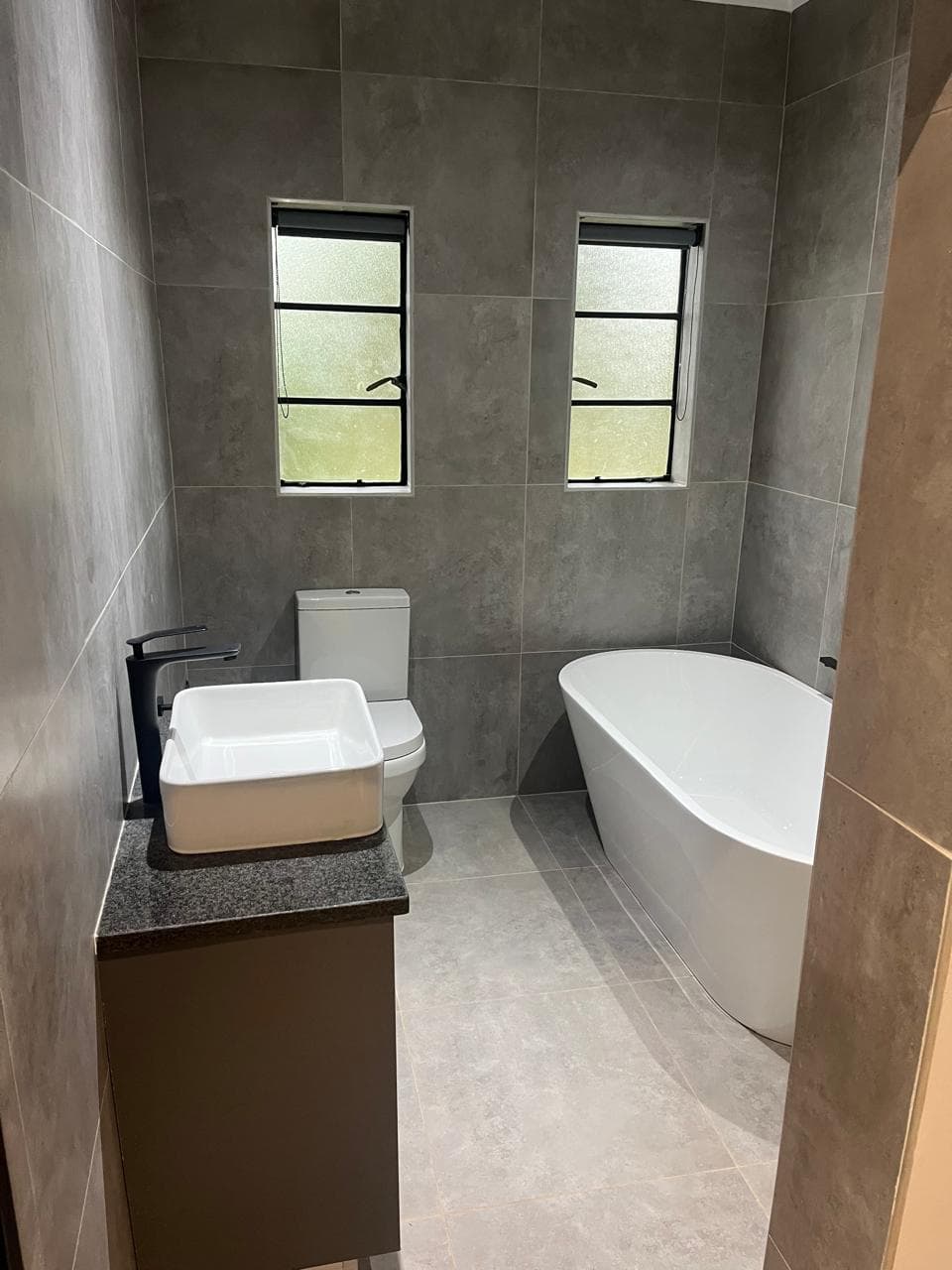 Bathroom vanity with a granite and quartz-style surface