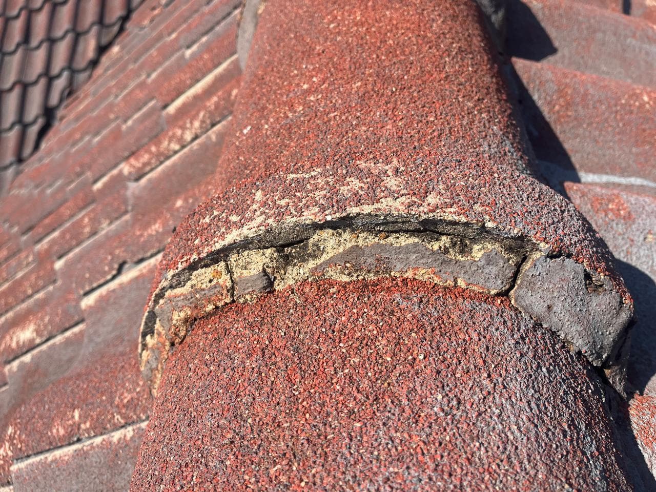 Cracked ridge tile mortar on a residential roof